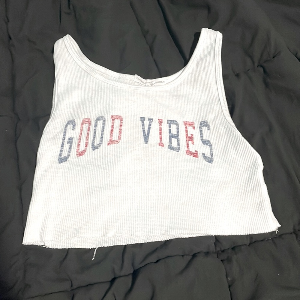 White crop top that says good vibes on it